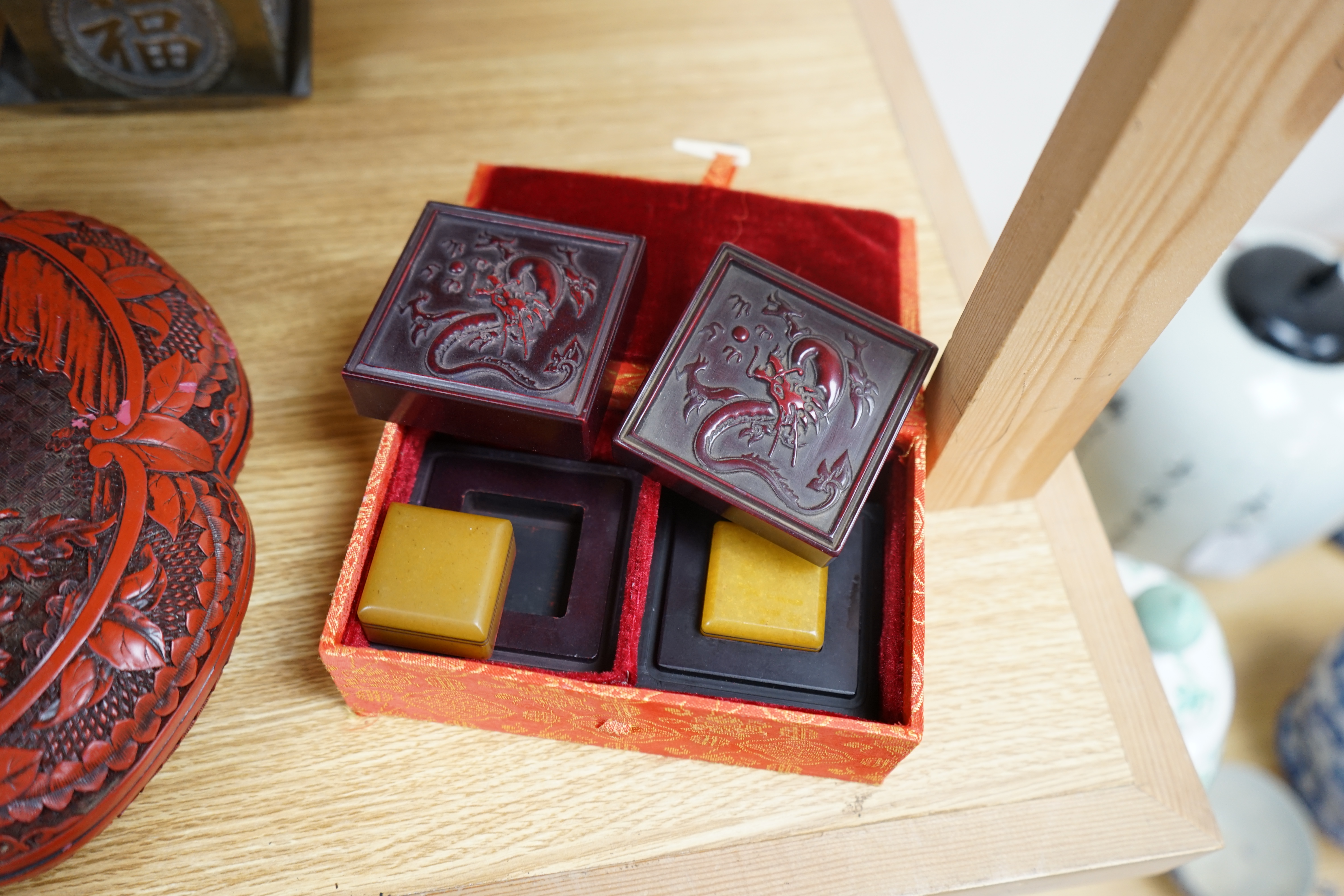 A collection of Chinese and Japanese items to include a lacquered box, a bronze tripod censer, a white metal box and carved seals, largest 25cm wide. Condition - mostly fair